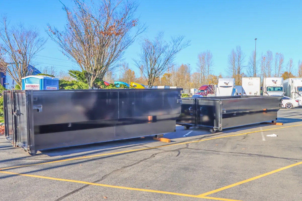 Professional dumpster rental service with roll-off container on residential driveway in Zuni Pueblo